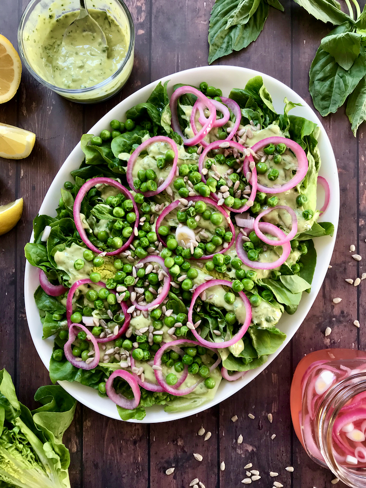 Spring produce is here to stay! This Gem Lettuce, Pickled Onion, Pea, and Sunflower Seed Salad tastes like Spring and is served with a creamy vegan Lemon-Basil Avocado Dressing