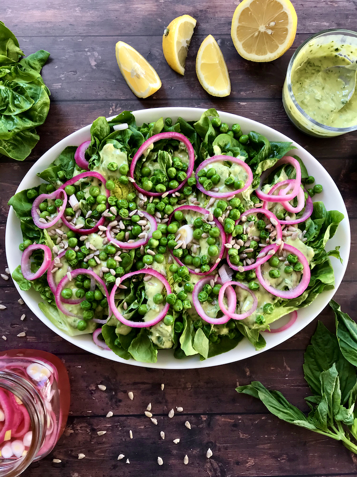 Spring produce is here to stay! This Gem Lettuce, Pickled Onion, Pea, and Sunflower Seed Salad tastes like Spring and is served with a creamy vegan Lemon-Basil Avocado Dressing
