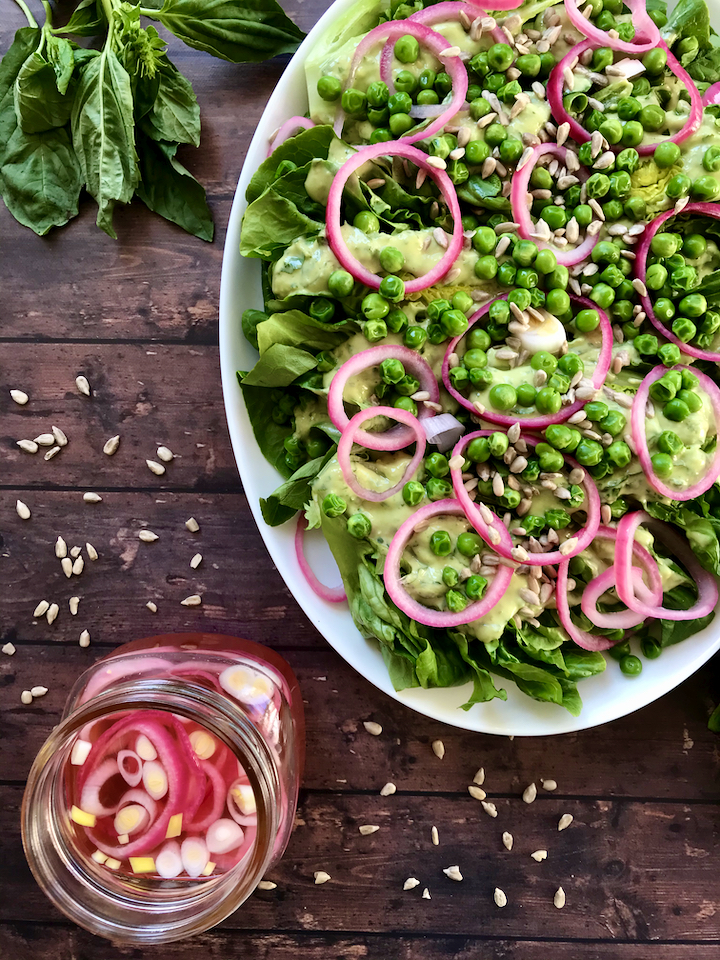 Spring produce is here to stay! This Gem Lettuce, Pickled Onion, Pea, and Sunflower Seed Salad tastes like Spring and is served with a creamy vegan Lemon-Basil Avocado Dressing.