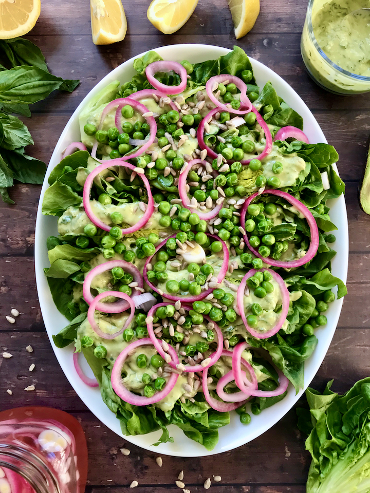 Spring produce is here to stay! This Gem Lettuce, Pickled Onion, Pea, and Sunflower Seed Salad tastes like Spring and is served with a creamy vegan Lemon-Basil Avocado Dressing